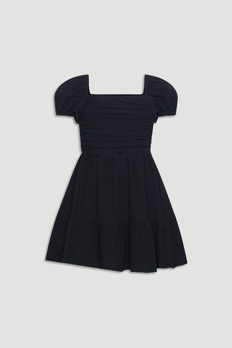 Black textured mini dress with puff sleeves and a gathered skirt for an easy, stylish girls' outfit.