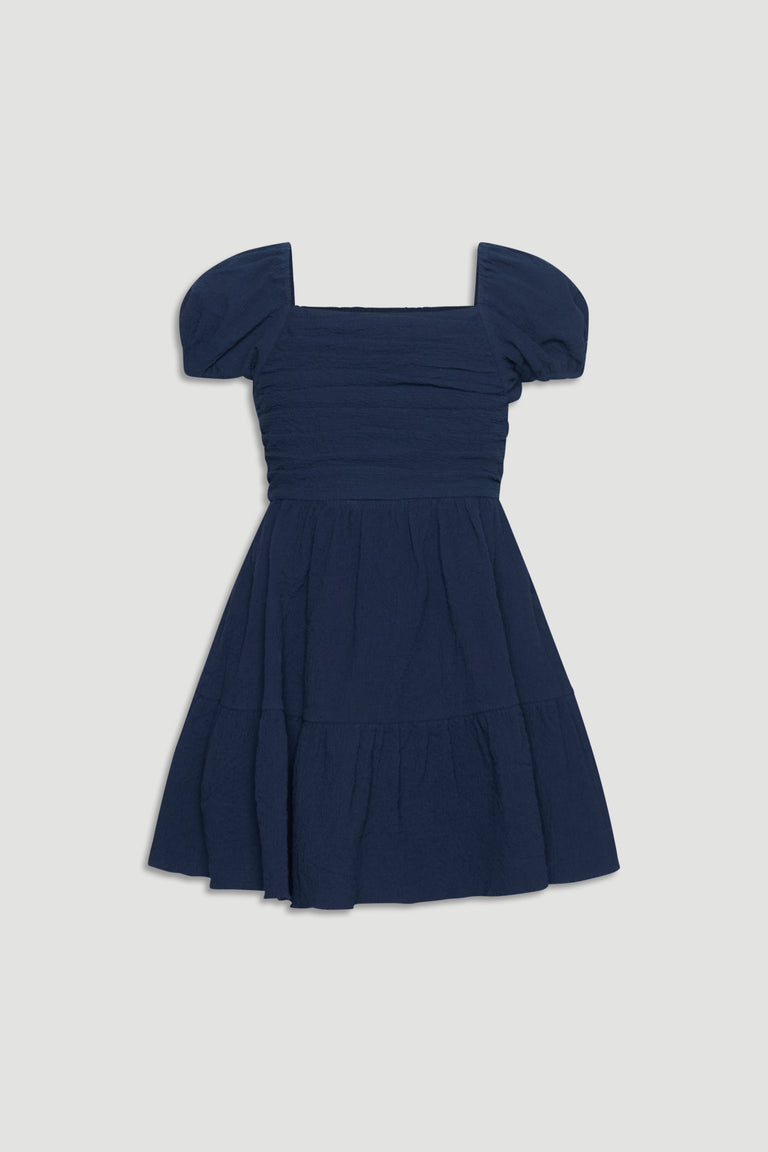 Navy blue textured mini dress with puff sleeves and a gathered skirt for a charming, playful fit.