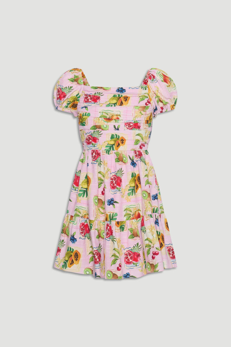 Girls mini dress featuring puff sleeves and a vibrant fruit print on a soft pink background for playful style