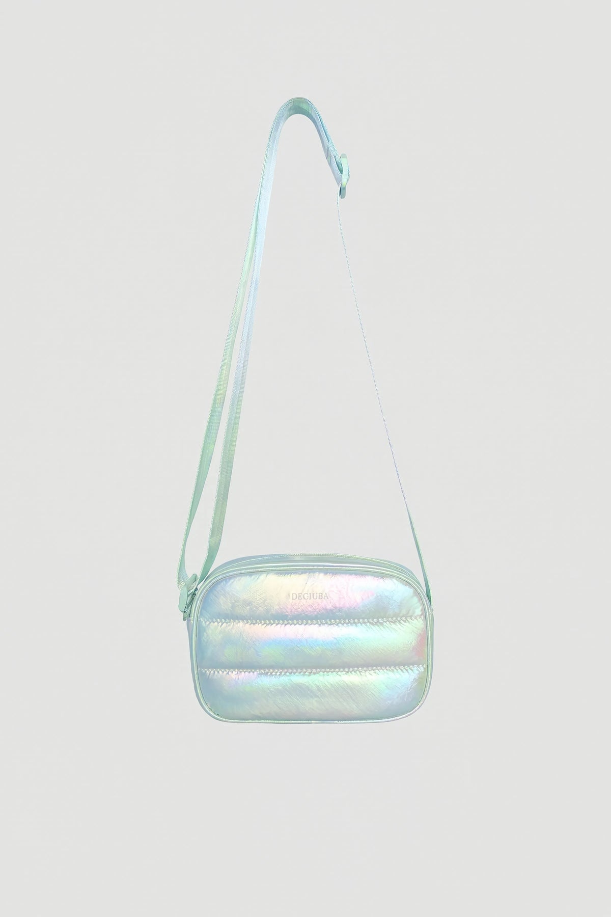 Iridescent padded small crossbody bag with adjustable strap and zip closure against plain background