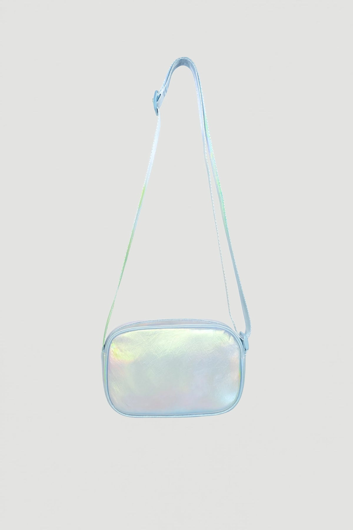 Iridescent padded crossbody bag with adjustable strap and zip closure against plain background