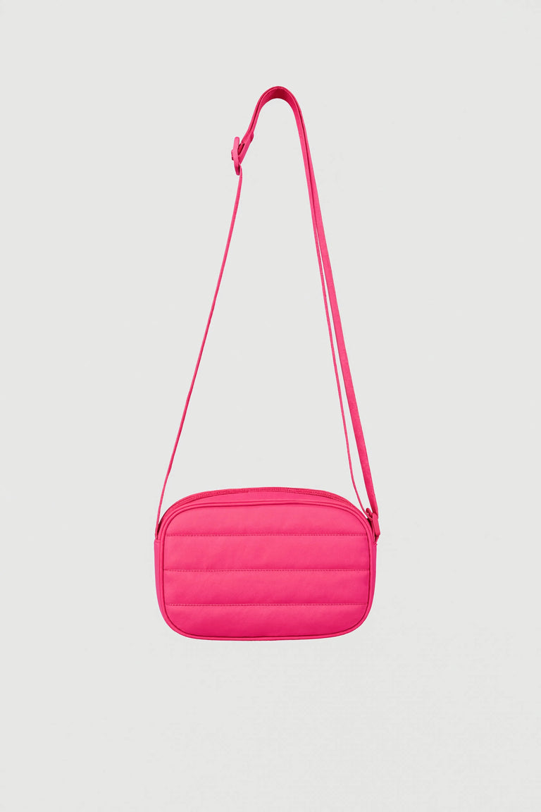 Bright pink padded crossbody bag with adjustable strap and zip closure against plain background