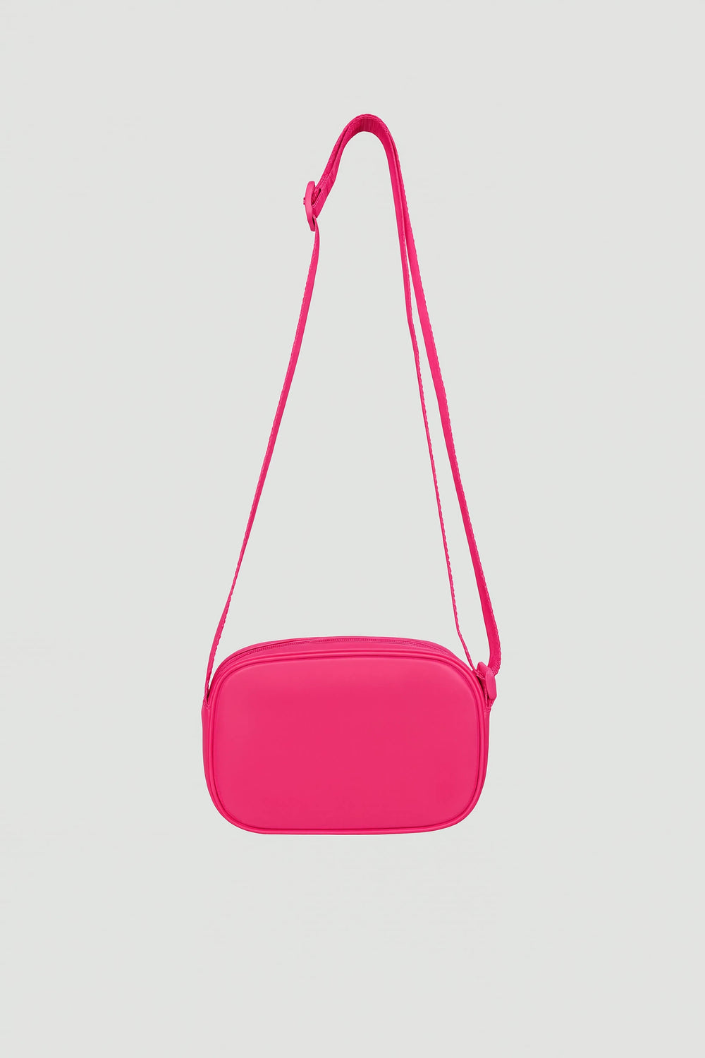 Bright pink padded crossbody bag with adjustable strap and zip closure shown against light background