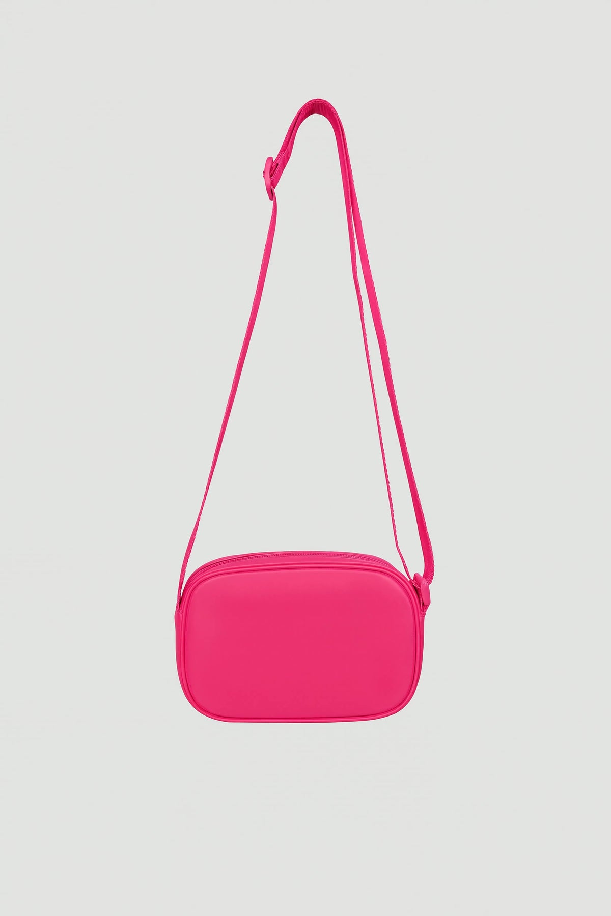 Bright pink padded crossbody bag with adjustable strap and zip closure shown against light background