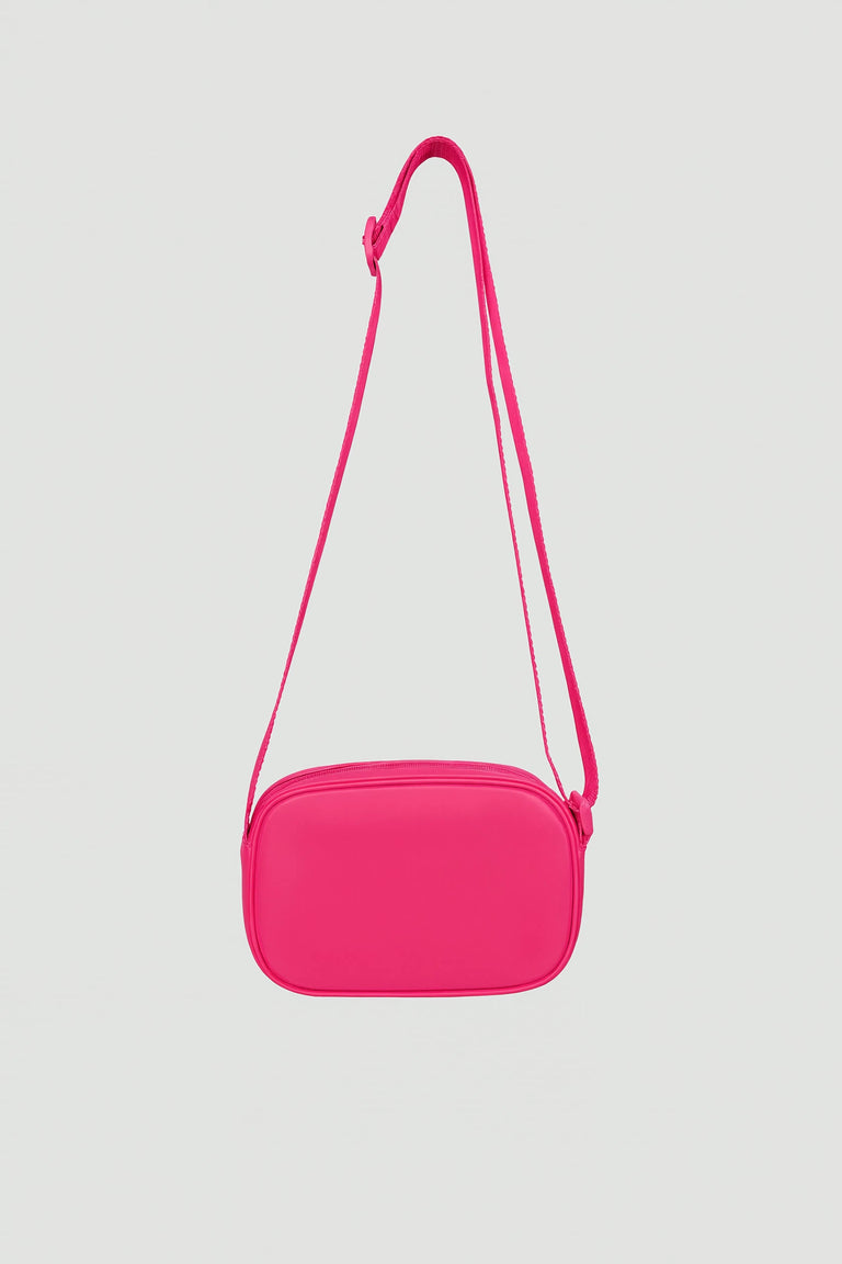 Bright pink padded crossbody bag with adjustable strap and zip closure shown against light background