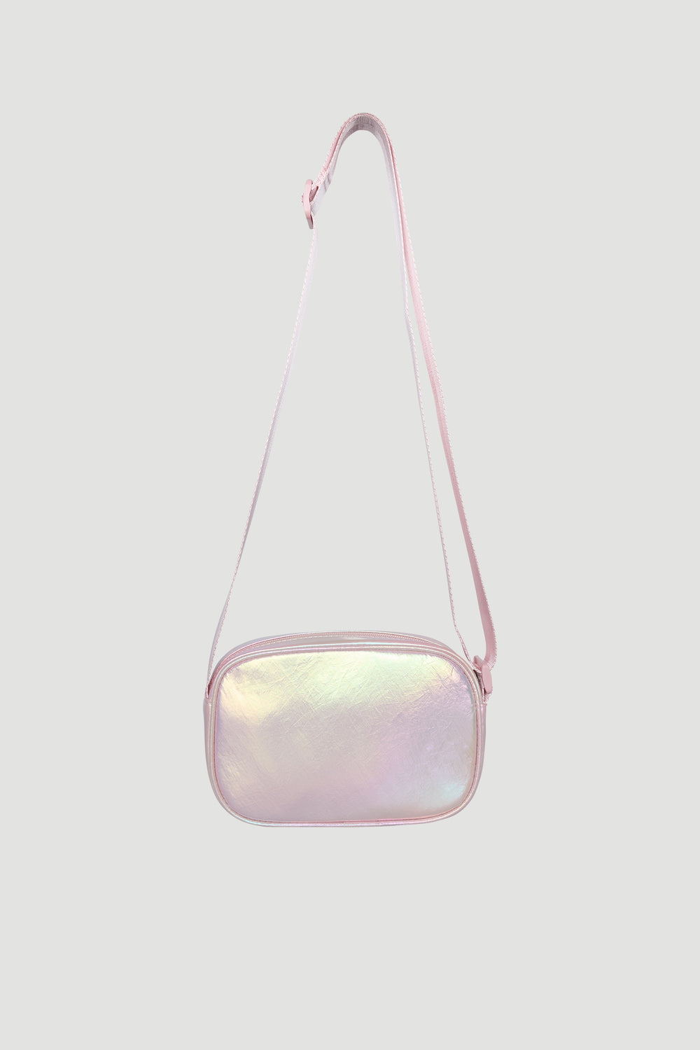 Small iridescent pink crossbody bag for girls with adjustable strap and soft padded texture.