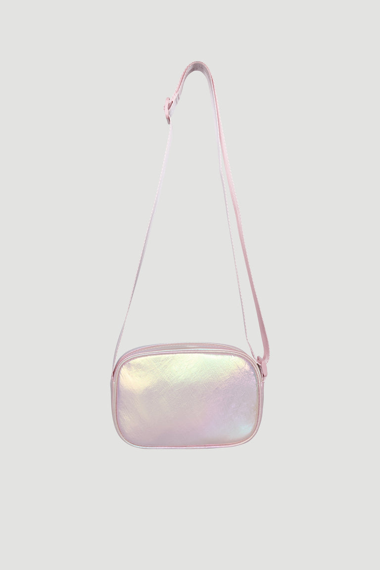 Small iridescent pink crossbody bag for girls with adjustable strap and soft padded texture.