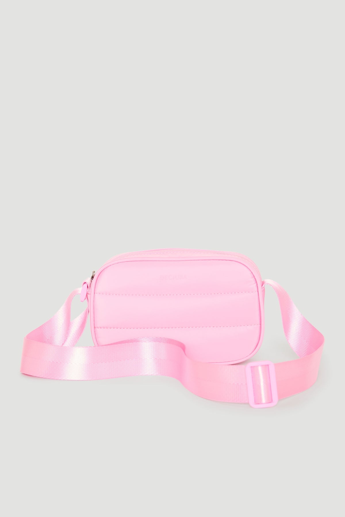 Small padded pink crossbody bag for girls with an adjustable satin strap, perfect for everyday use.