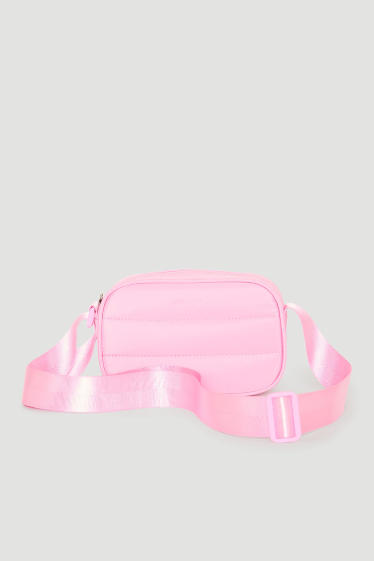 Small padded pink crossbody bag for girls with an adjustable satin strap, perfect for everyday use.