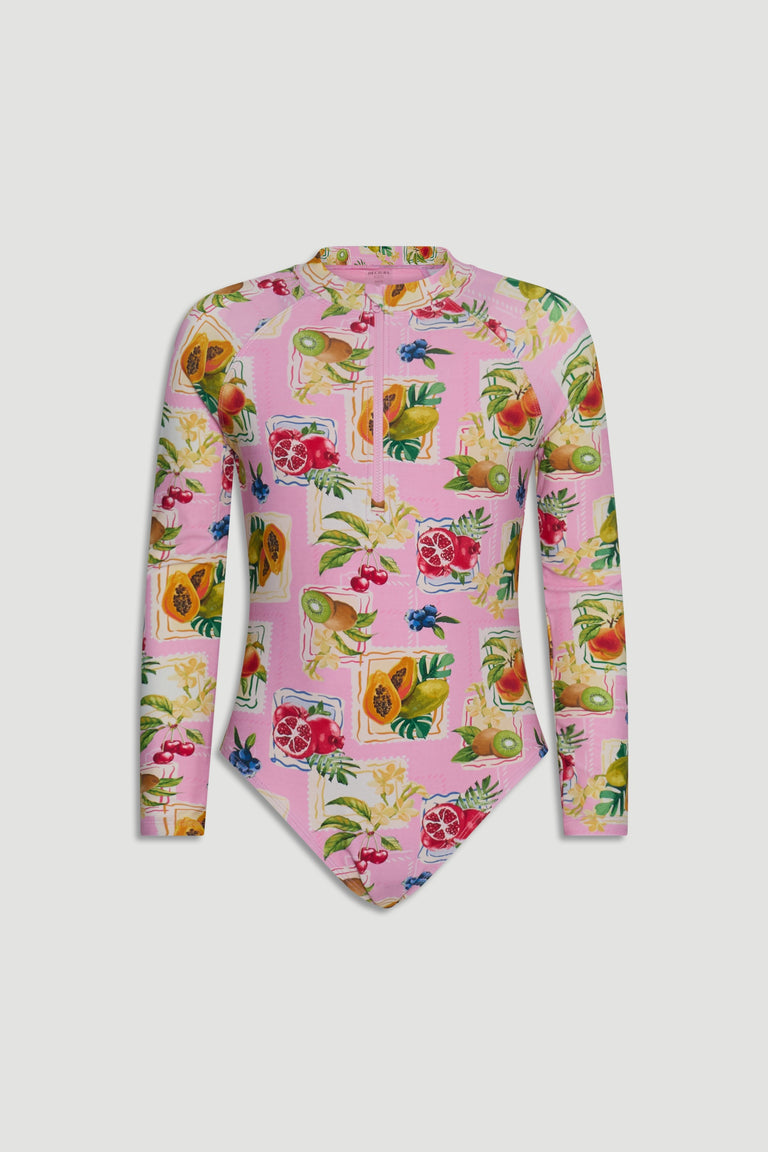 Girls long sleeve swimsuit with vibrant tropical fruit print on a soft pink background, featuring a high neckline and zip front.