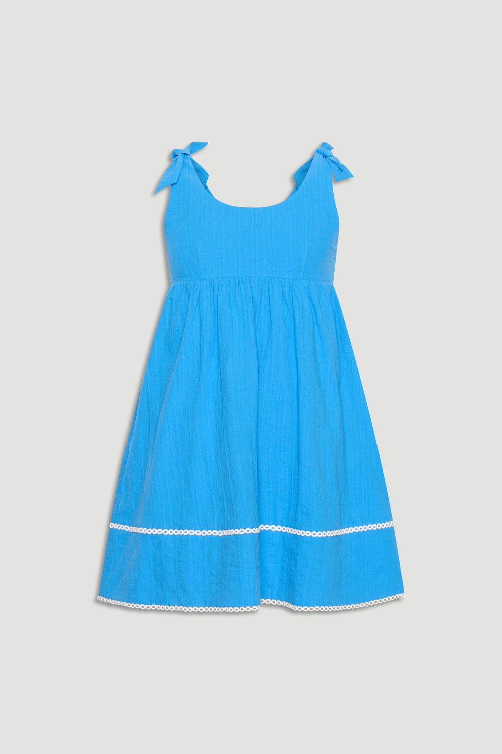 Bright blue mini dress featuring tie shoulder straps and delicate white trim near the hem for a playful finish.