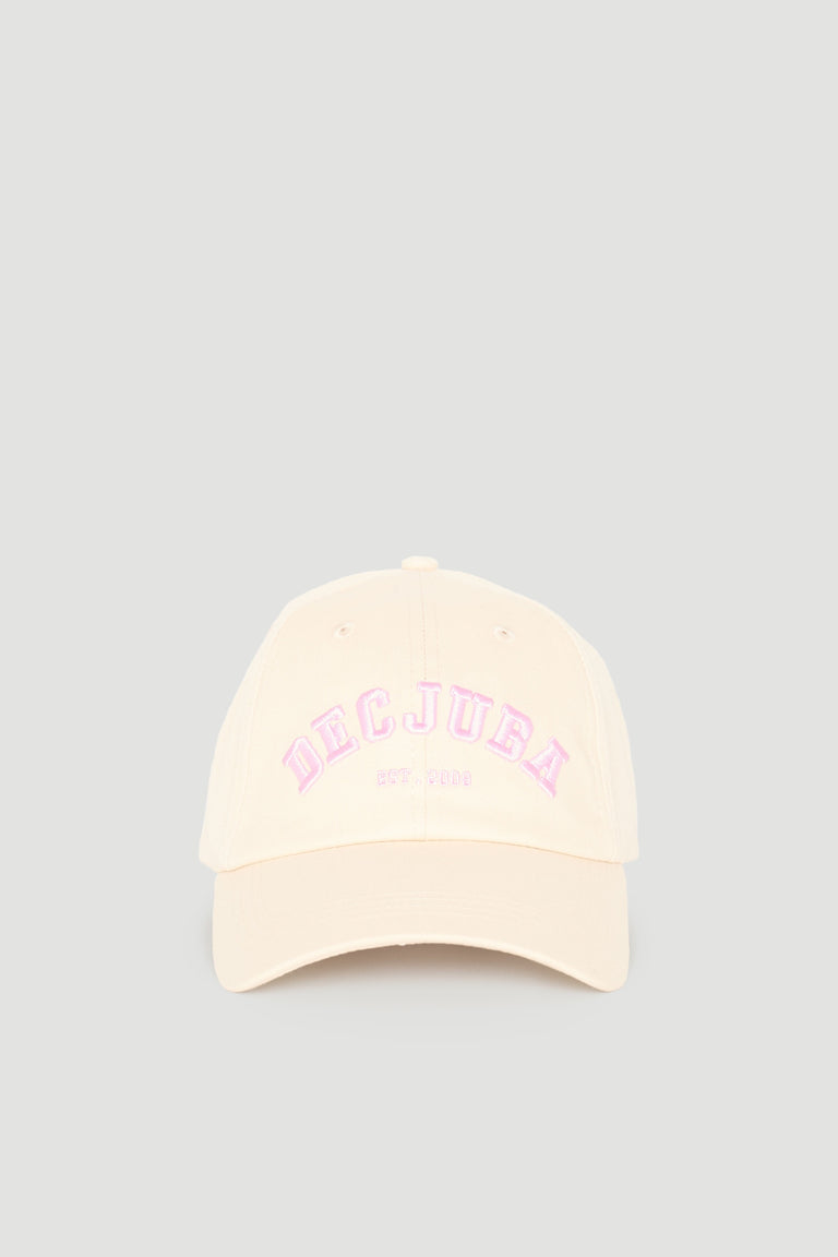Cream-coloured girls varsity cap with soft pink embroidered logo, featuring a classic curved brim design.