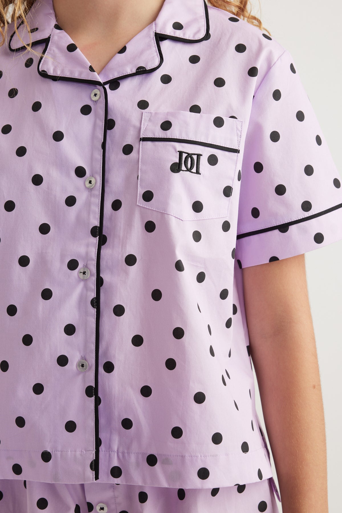 Girls lavender polka dot pyjama shirt with a collared neckline short sleeves and chest pocket