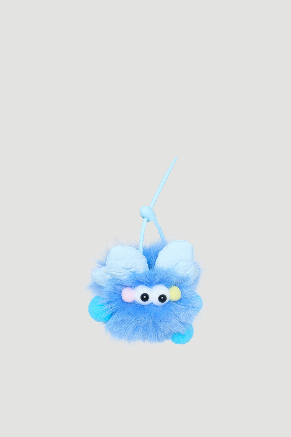 Fluffy blue monster bag charm with soft texture and playful eyes, perfect for adding fun to girls’ accessories.