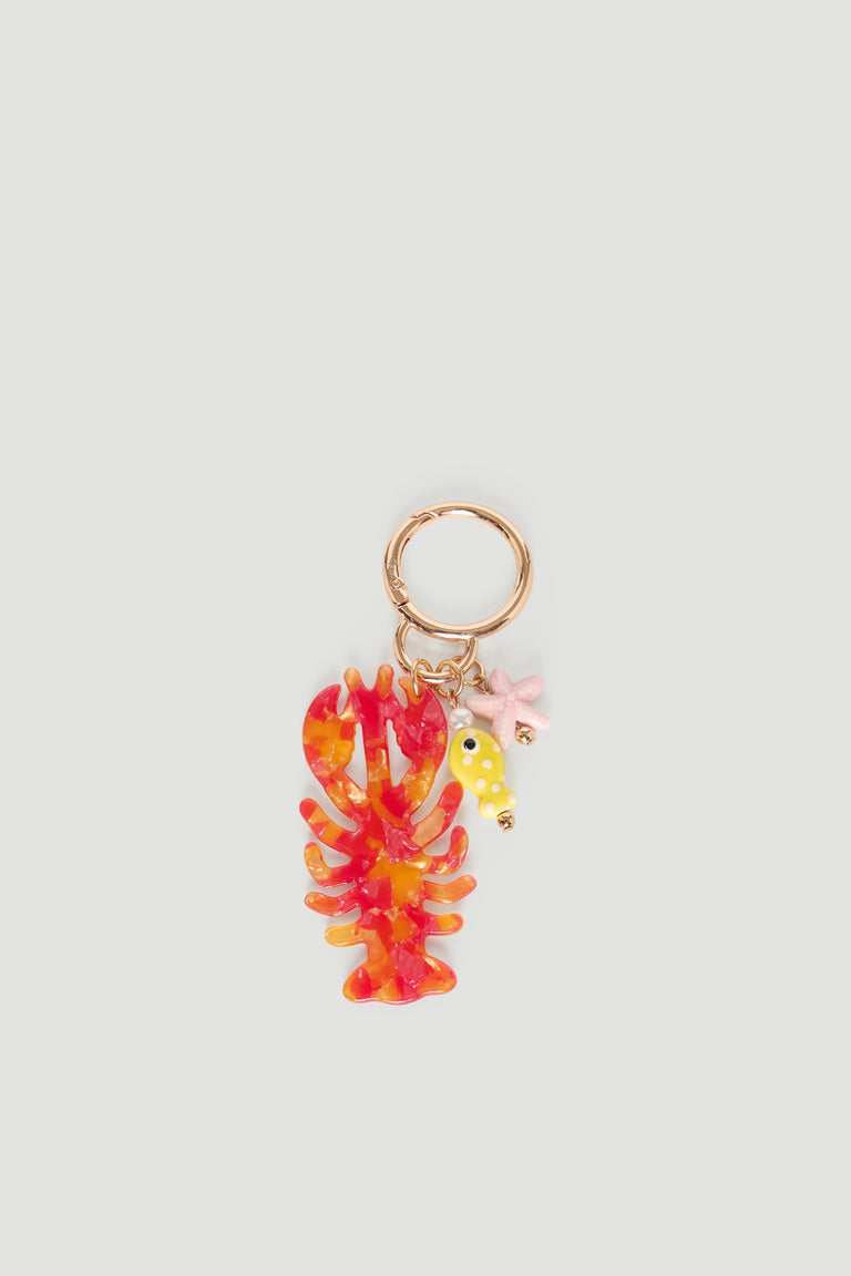 Gold hoop keyring with colorful red lobster charm, yellow fish, and small pink starfish accents
