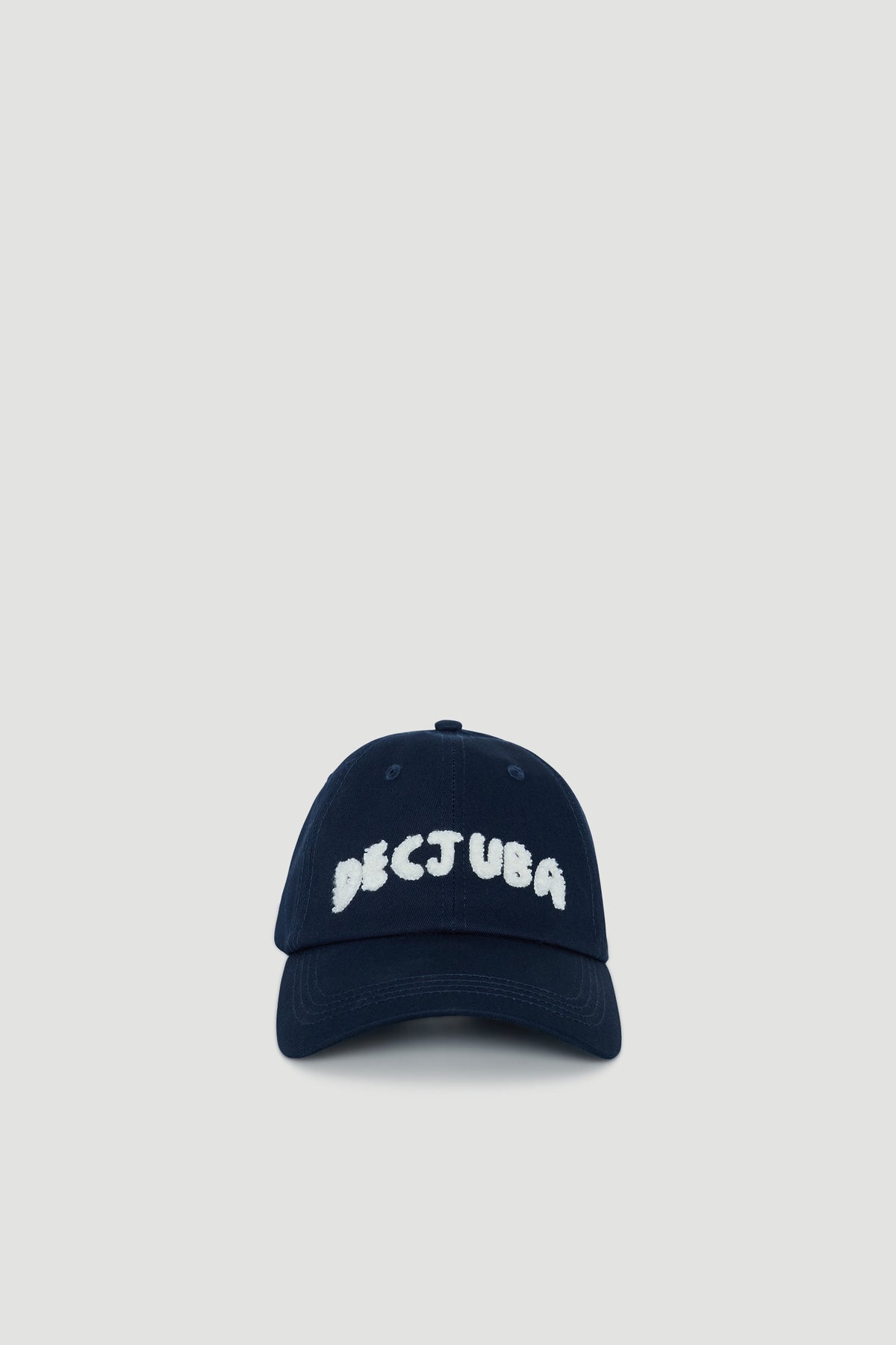 Navy blue cap for girls with white textured lettering and a curved brim for casual everyday wear