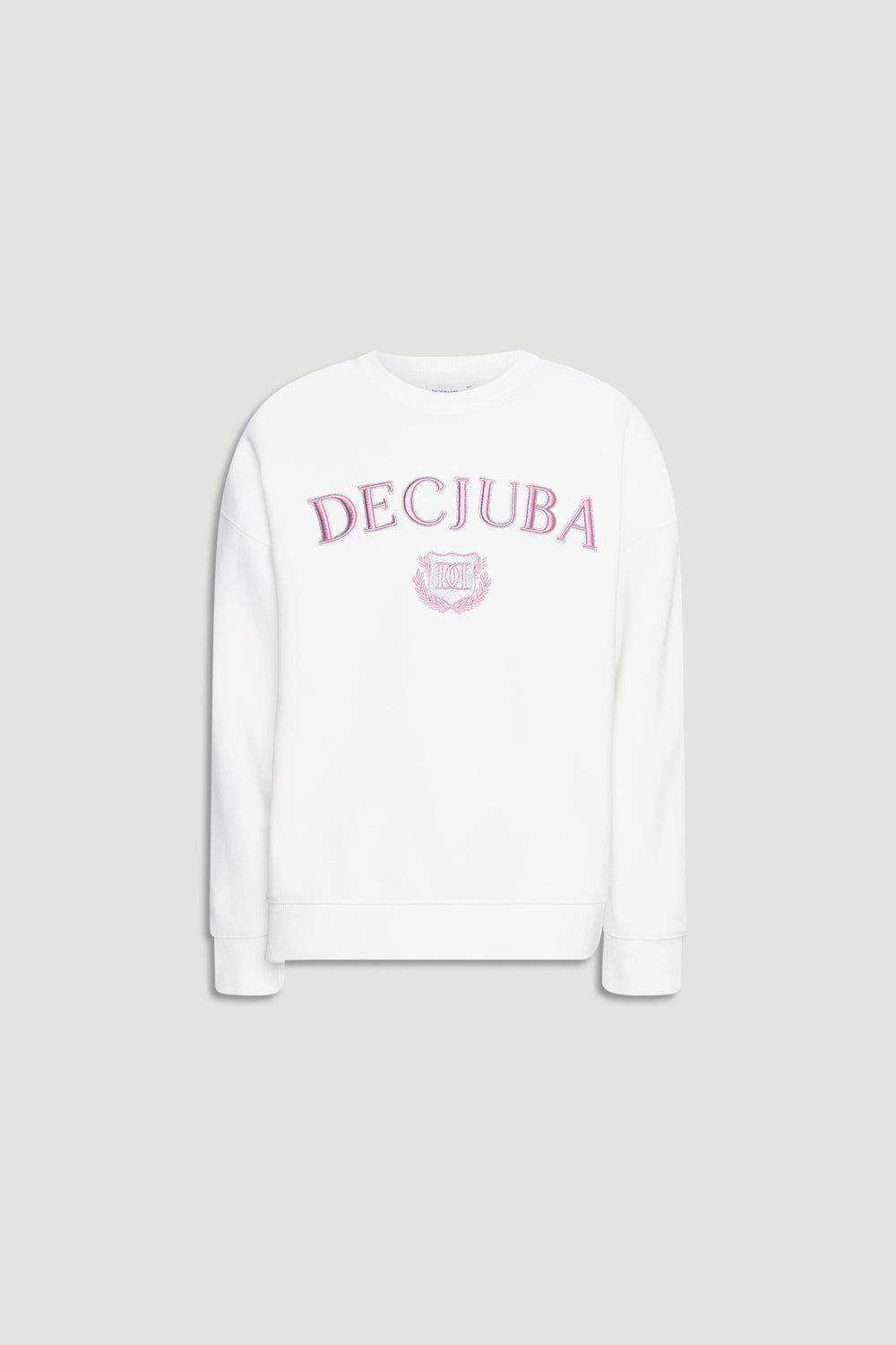 White oversized girls sweatshirt with pink embroidered logo and crest on front against plain background
