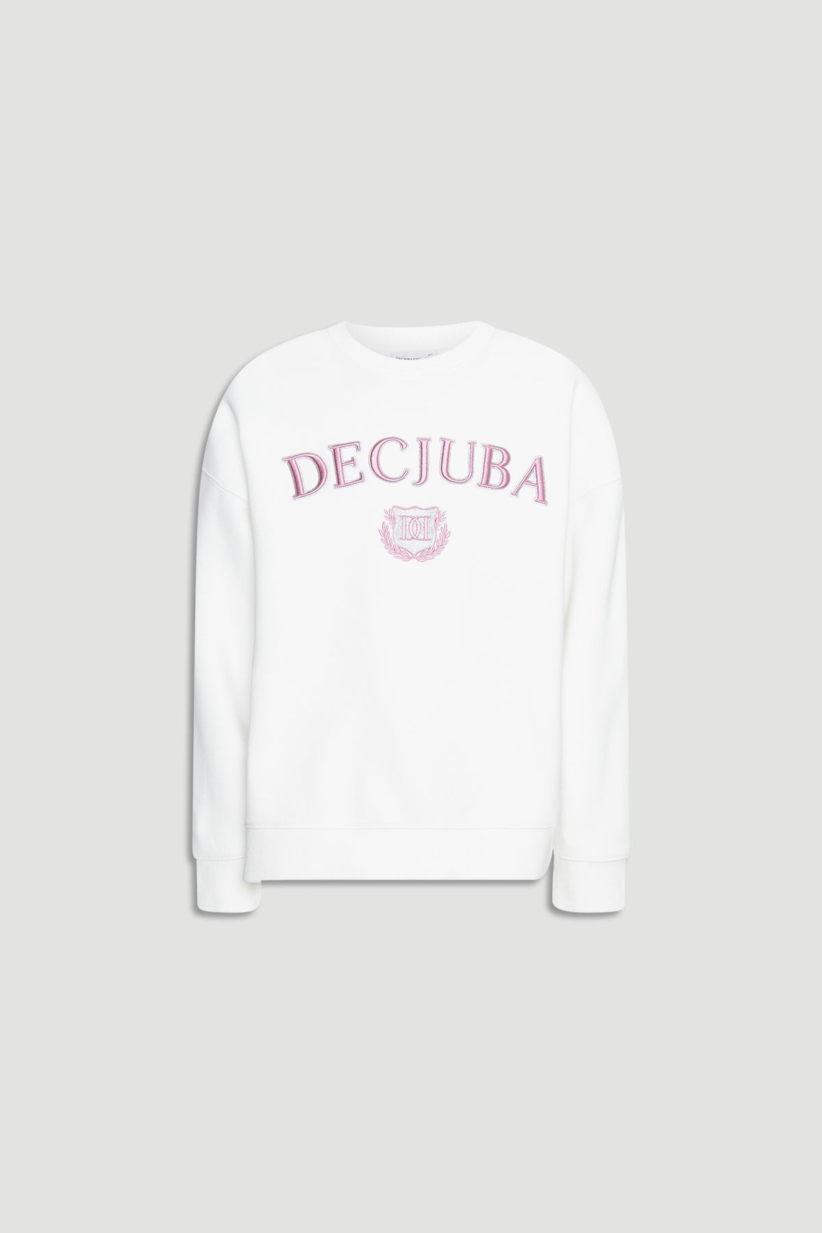 White oversized girls sweatshirt with pink embroidered logo and crest on front against plain background