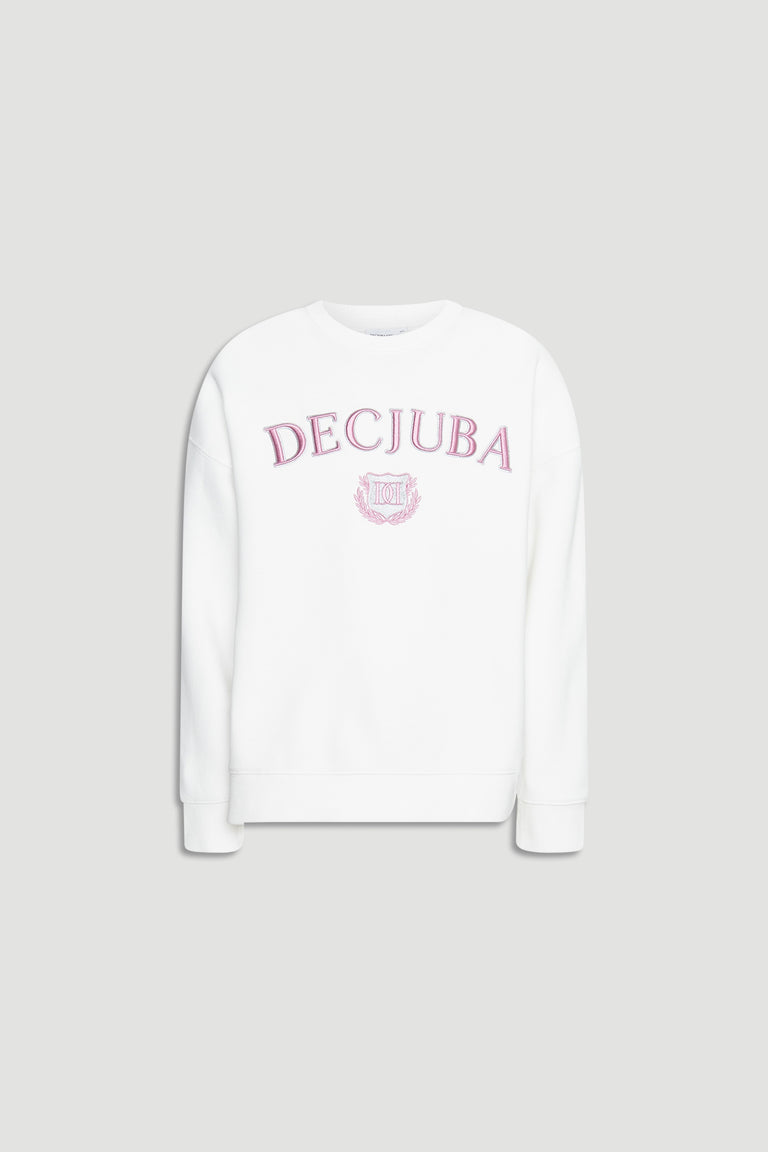White oversized girls sweatshirt with pink embroidered logo and crest on front against plain background