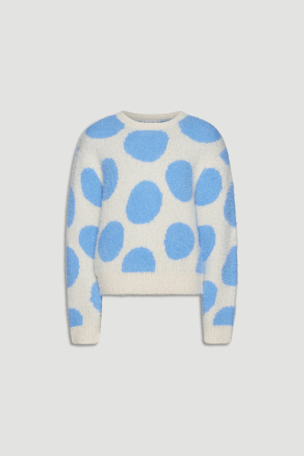 Soft cream knit jumper with large sky blue spots, featuring a cozy fluffy texture and relaxed fit for girls.