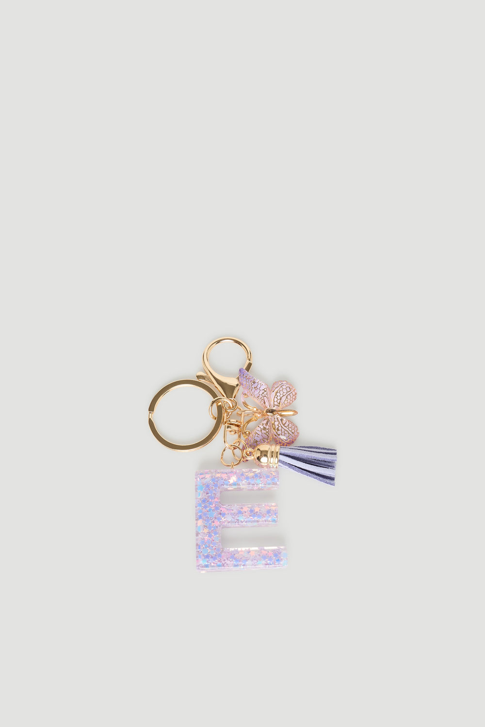 Girls Initial Key Ring featuring a glittery letter E charm, delicate butterfly, and striped tassel detail by DECJUBA.