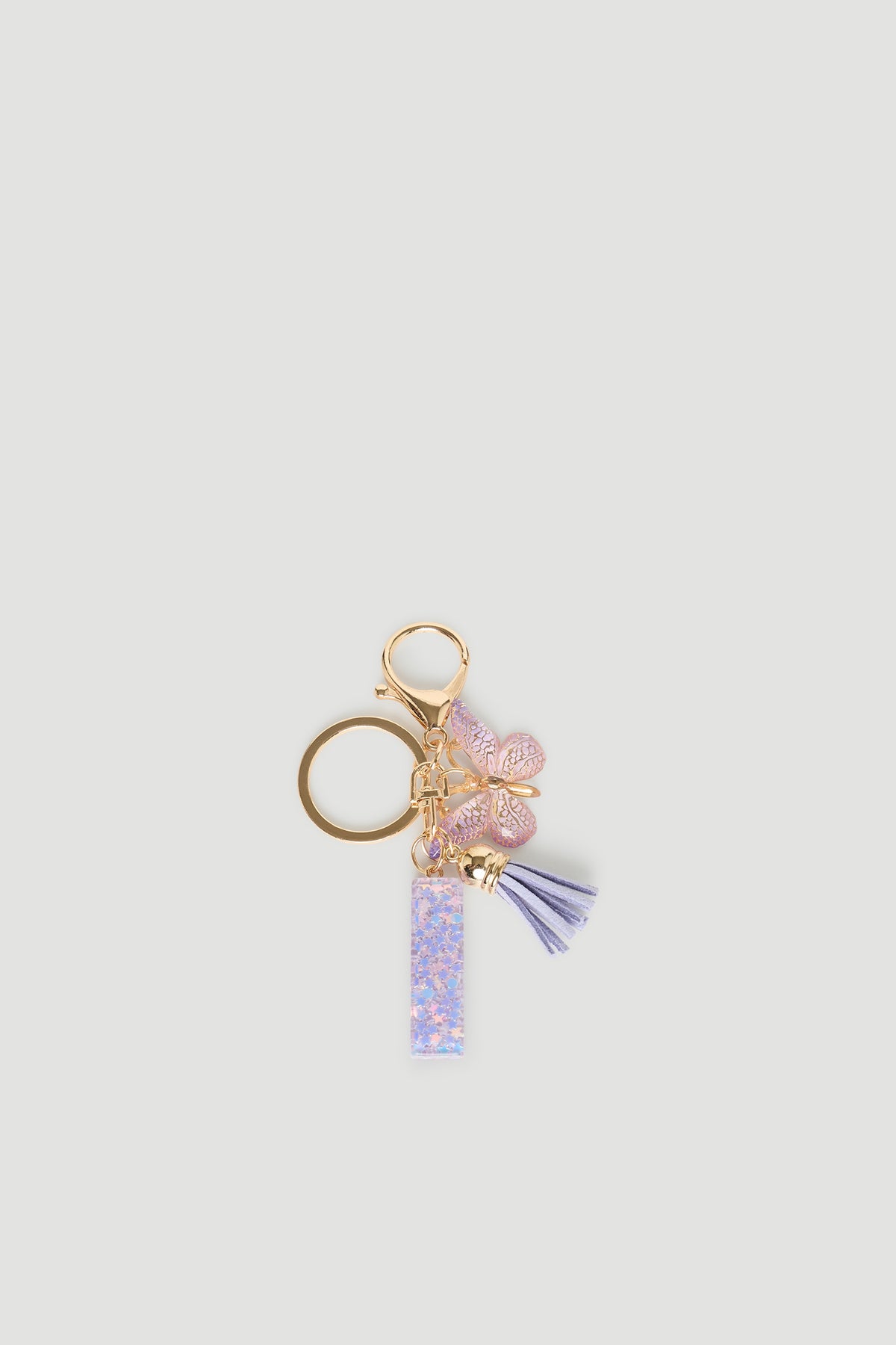 Girls Initial Key Ring with pastel purple letter charm, butterfly detail, and soft tassel for playful accessory style.