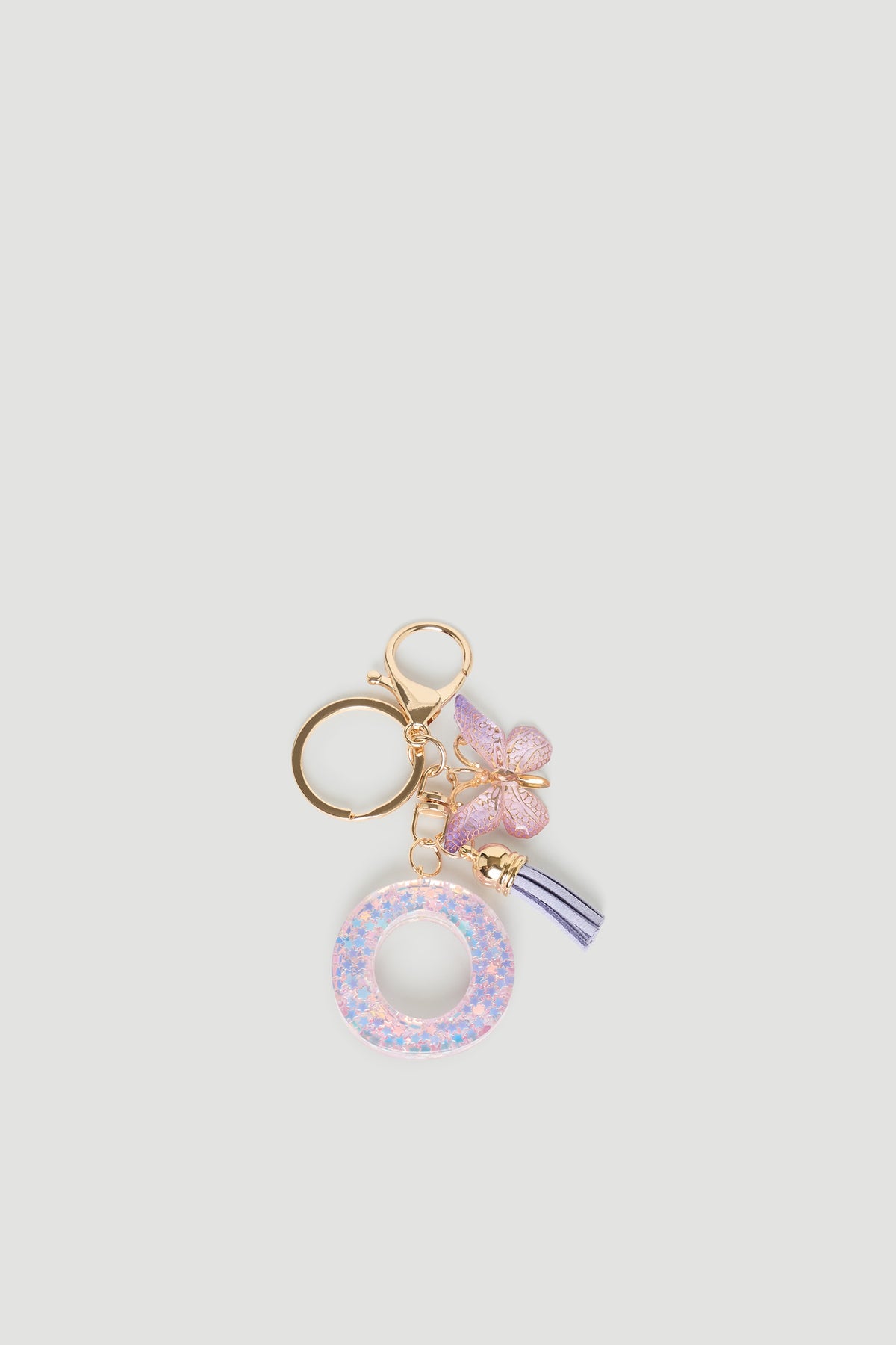 Girls Initial Key Ring featuring a glittery pastel letter O, delicate butterfly charm, and soft lilac tassel detail by DECJUBA.