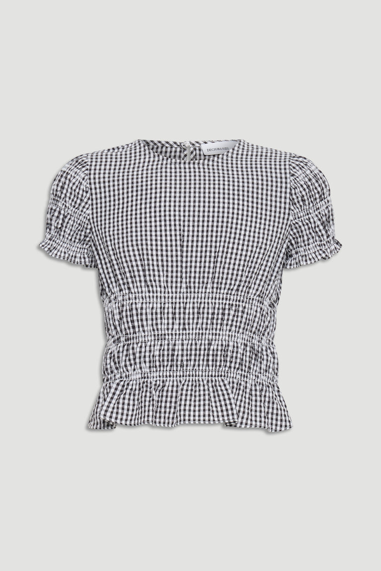 Black and white gingham top for girls featuring puff sleeves and a gathered waist with ruffle hem detail.