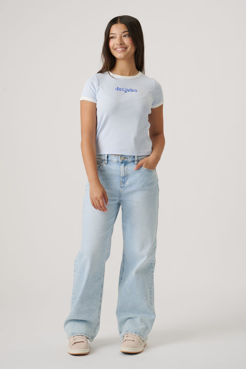 Teen girl wearing a sky blue cropped tee with logo paired with relaxed light wash wide-leg jeans and sneakers
