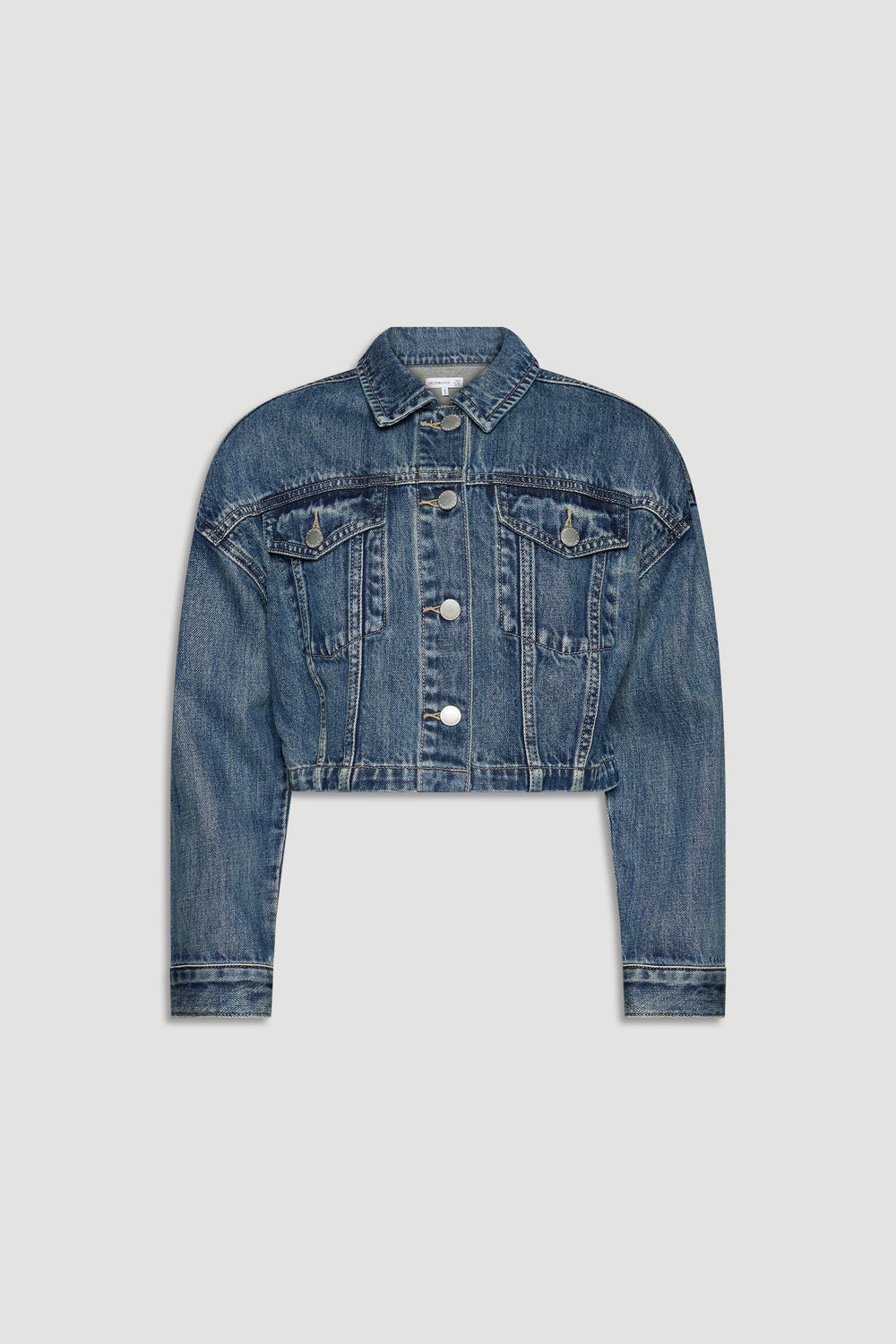 Cropped girls denim jacket in classic blue wash with button front and chest flap pockets for casual layering.
