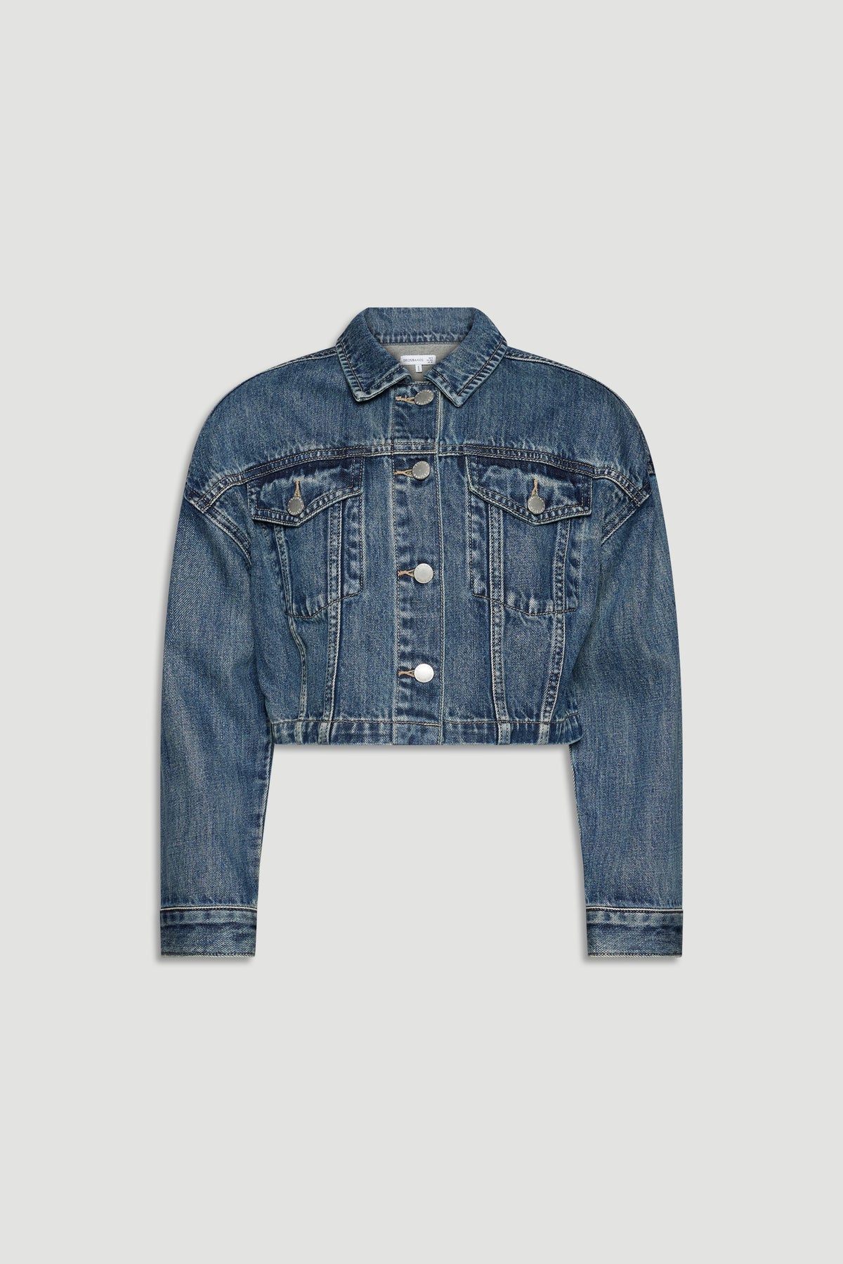 Cropped girls denim jacket in classic blue wash with button front and chest flap pockets for casual layering.