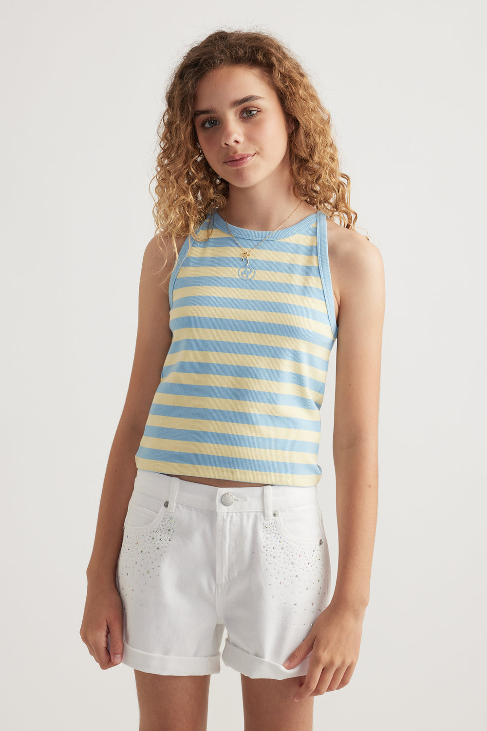Girl wearing a blue and yellow striped ribbed racer tank with white shorts