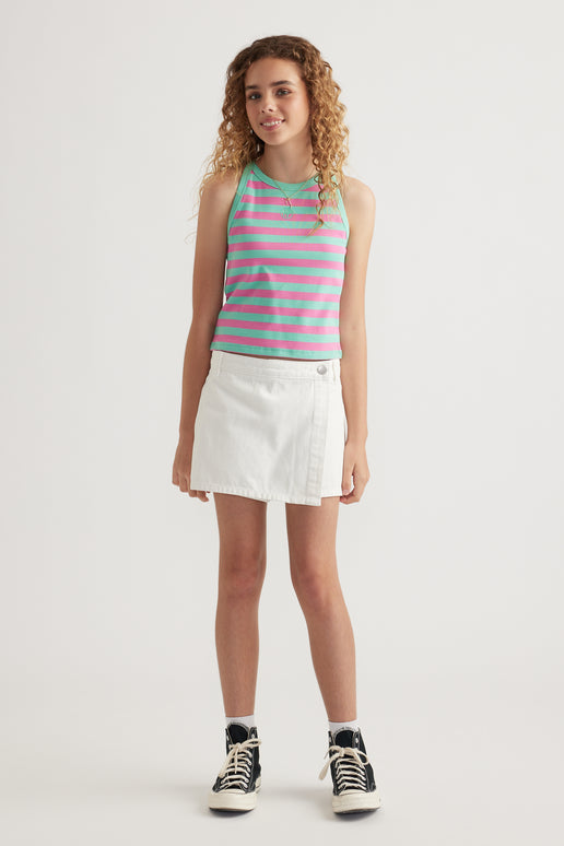 Girl wearing a pink and turquoise striped rib racer tank with a white skirt and black high top sneakers