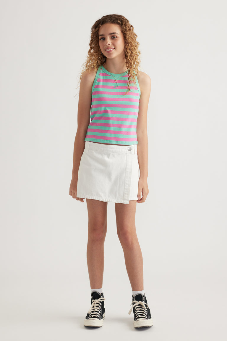 Girl wearing a pink and turquoise striped rib racer tank with a white skirt and black high top sneakers