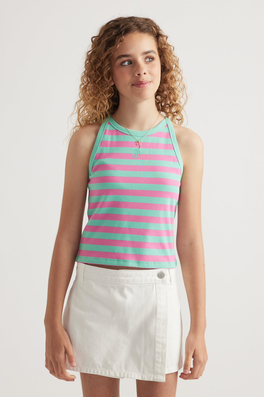 Girl wearing a mint green and pink striped rib racer tank with a white skirt