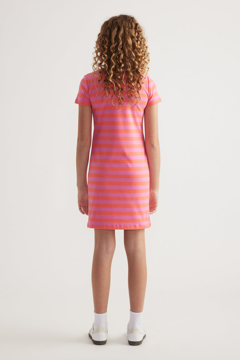 Back view of girl wearing a pink and orange striped ribbed T shirt dress with short sleeves and sneakers