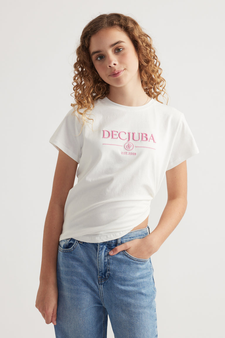 Girl wearing a white Decjuba heritage graphic T shirt with blue jeans