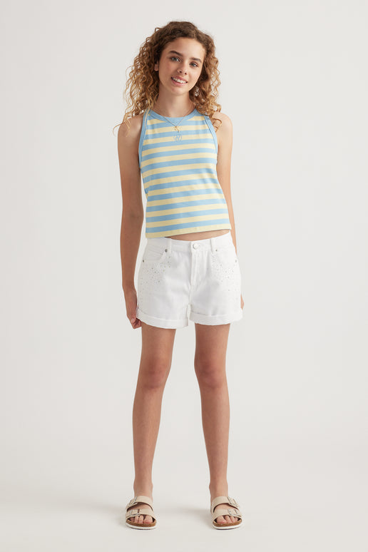Girl wearing white high rise denim shorts with rolled cuffs and a blue striped tank top
