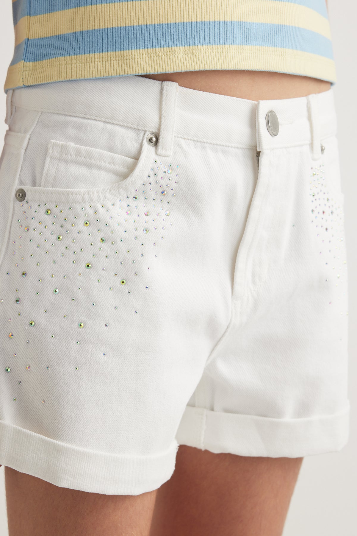White denim shorts with rhinestone detailing, rolled cuffs and a high rise waist