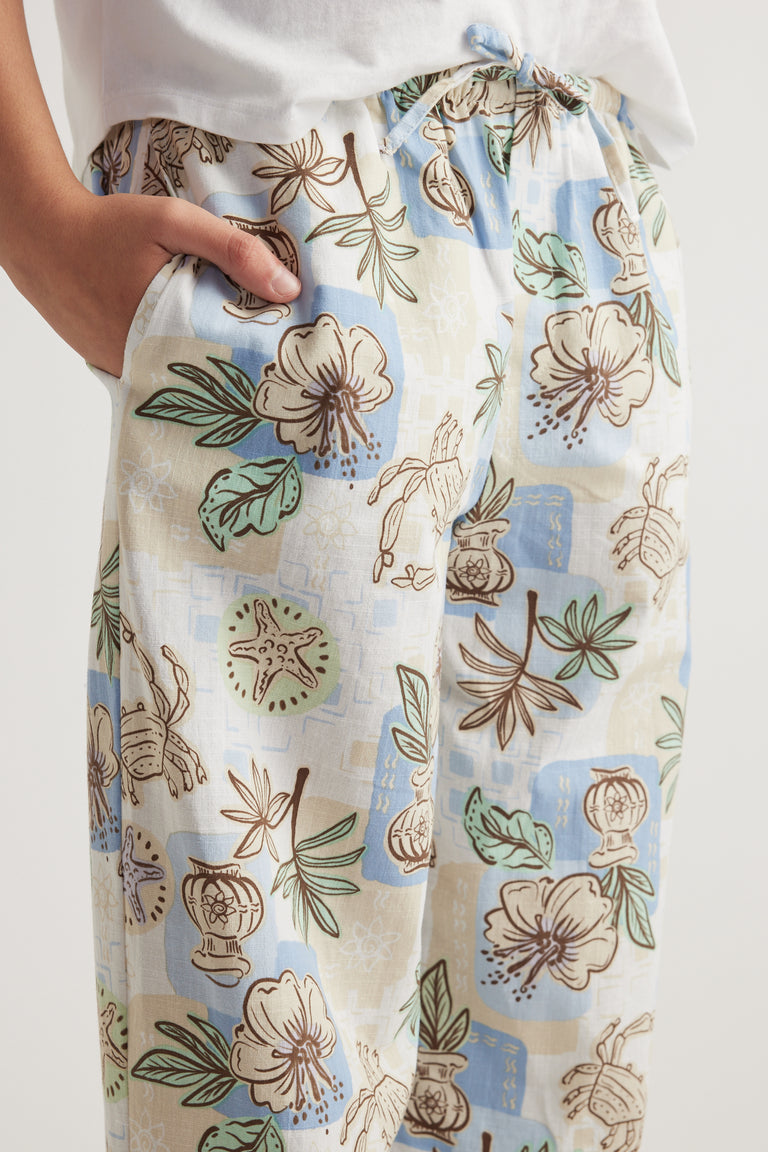 Girls cream wide leg pants with an elastic waist and blue floral botanical print