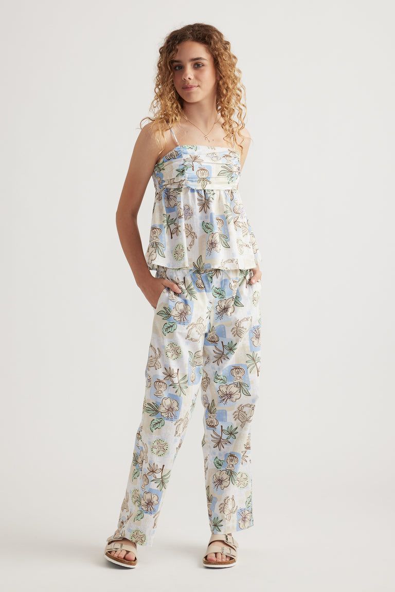 Model wearing a floral camisole with matching wide leg pants and sandals