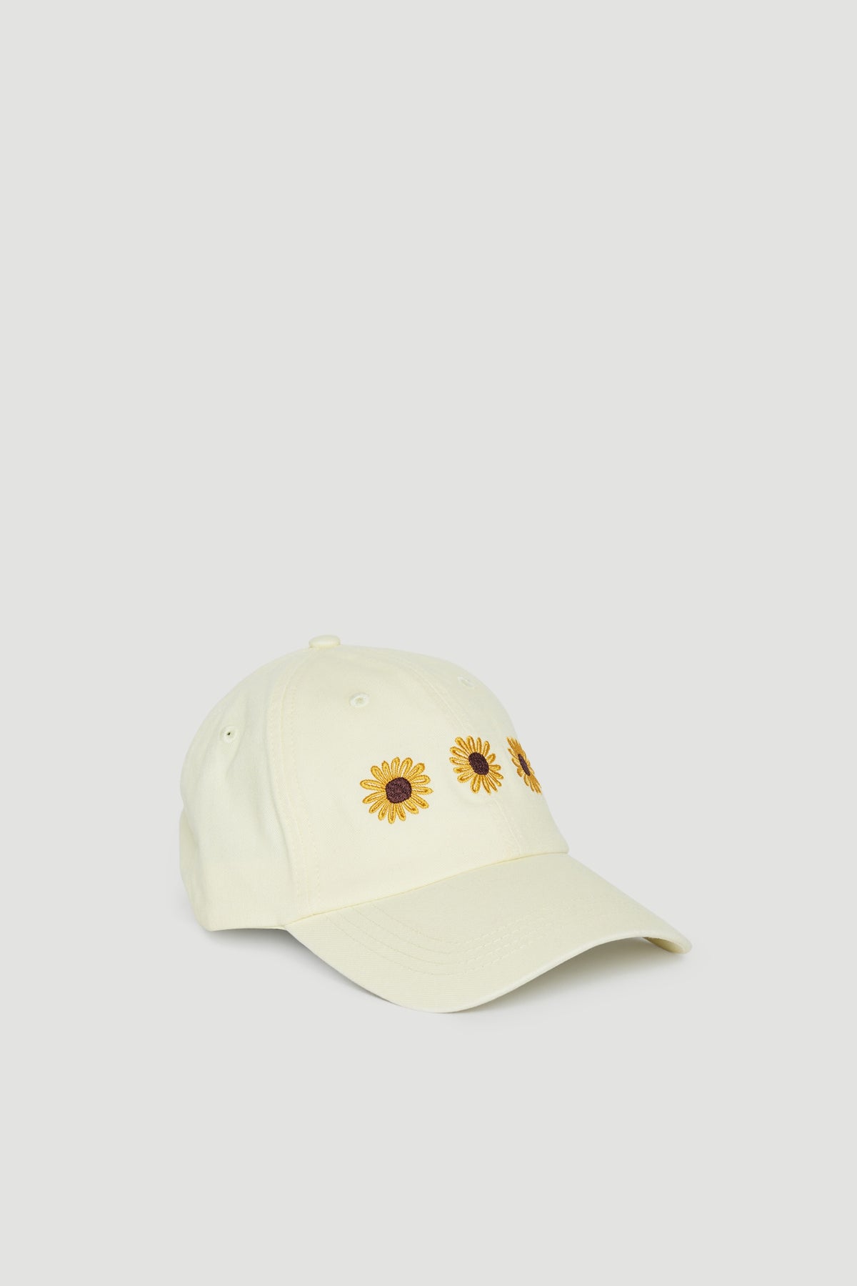 Girls cream baseball cap with sunflower motifs and curved brim