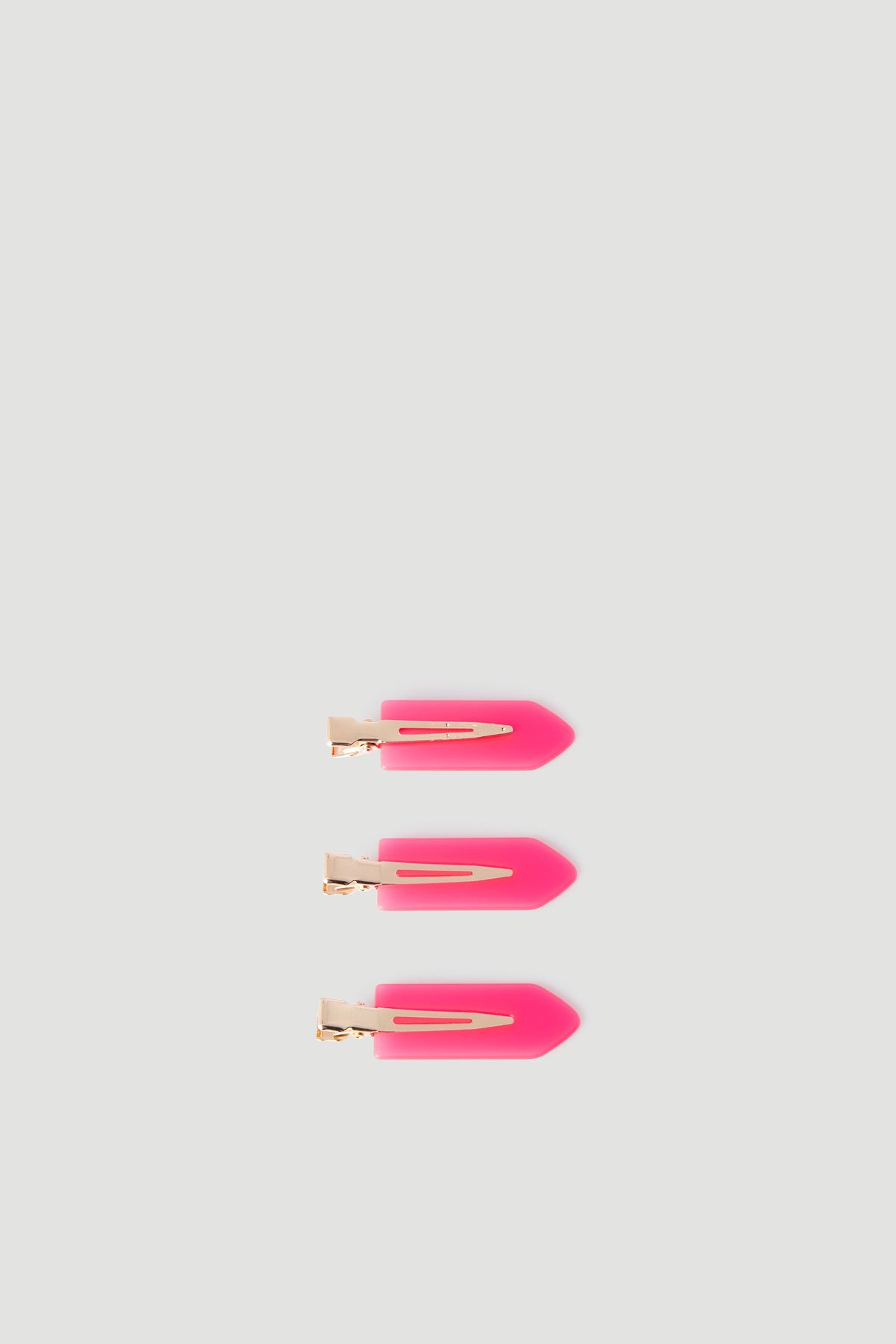Set of three vibrant pink hair clips with gold-tone metal clasps, designed for easy styling and everyday wear.