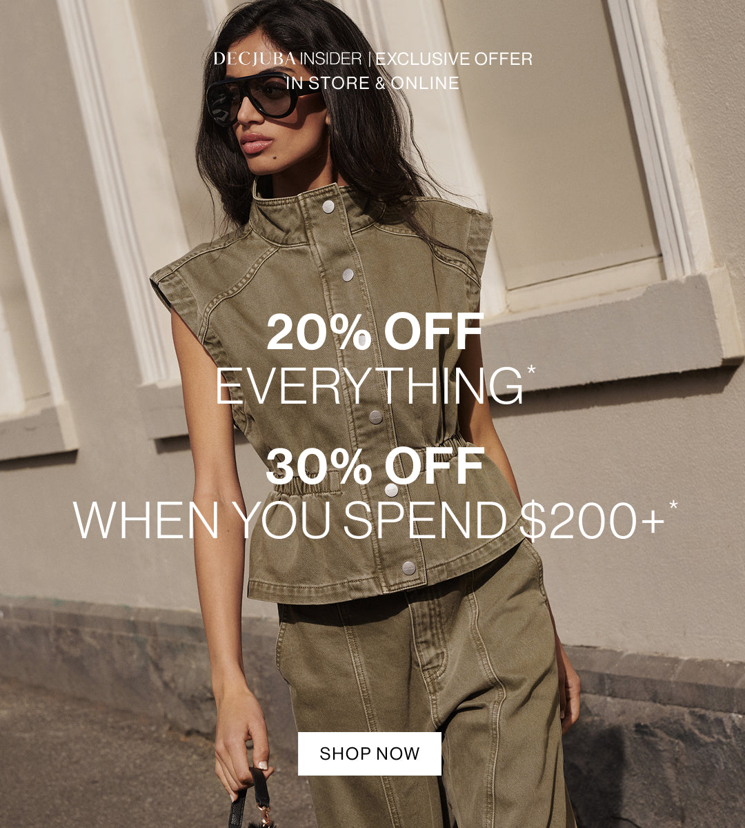 A woman wearing a sleeveless olive green denim vest and matching pants stands outdoors against a beige building wall, with large promotional text overlays reading '20% OFF EVERYTHING', '30% OFF WHEN YOU SPEND $200+', and a 'SHOP NOW' button.