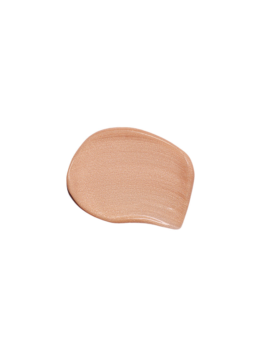 Peach-toned highlighting makeup swatch on a white background